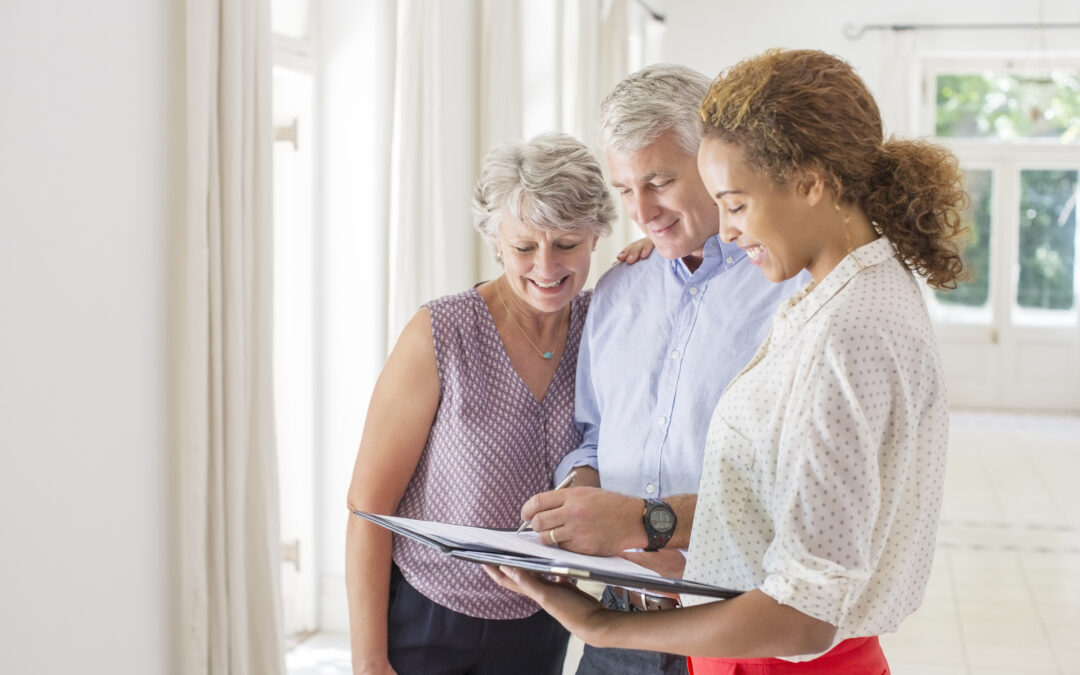 Older couple and woman signing documents